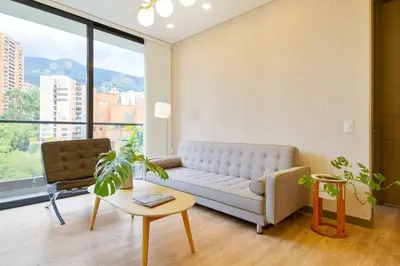 a living room with a couch and a table at The perfect stay in Medellín - 904 in Medellín