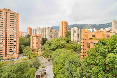 a view of a city with tall buildings and trees at The perfect stay in Medellín - 904 in Medellín