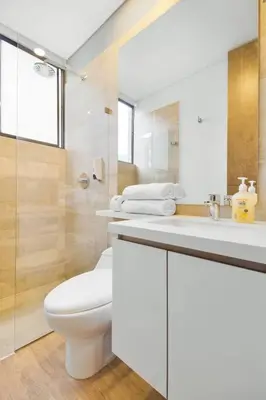 a white bathroom with a toilet and a sink at The perfect stay in Medellín - 904 in Medellín
