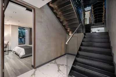 a staircase leading to a bedroom in a house at Tribeca Suites Medellin in Medellín