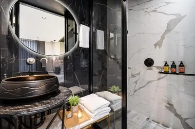 a bathroom with a sink and a mirror at Tribeca Suites Medellin in Medellín