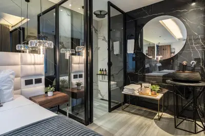 a bedroom with a shower and a bed and a mirror at Tribeca Suites Medellin in Medellín