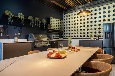 a kitchen with a table with a plate of food on it at Tribeca Suites Medellin in Medellín