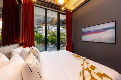 a bedroom with a bed with a television on a wall at Primavera Luxury Apartments Medellin in Medellín
