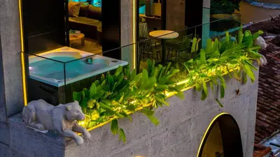 a store window with a statue of a dog and a sink at Primavera Luxury Apartments Medellin in Medellín