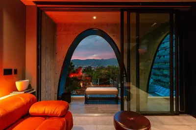 a room with a large window with a view of a bedroom at Primavera Luxury Apartments Medellin in Medellín