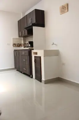 a kitchen with brown cabinets and a white floor at CASA ESTADIO MEDELLIN Apartamentos Turisticos renovados y modernos para Familias, Grupos o Delegaciones Deportivas - Sector Laureles-Estadio in Medellín