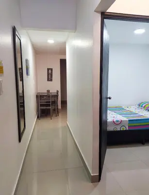 a hallway with a door leading to a bedroom at CASA ESTADIO MEDELLIN Apartamentos Turisticos renovados y modernos para Familias, Grupos o Delegaciones Deportivas - Sector Laureles-Estadio in Medellín
