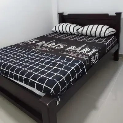a black and white bed with pillows on it at CASA ESTADIO MEDELLIN Apartamentos Turisticos renovados y modernos para Familias, Grupos o Delegaciones Deportivas - Sector Laureles-Estadio in Medellín
