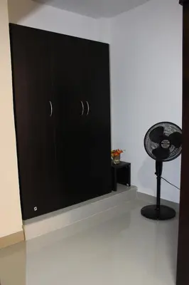 a black cabinet in a room with a fan at CASA ESTADIO MEDELLIN Apartamentos Turisticos renovados y modernos para Familias, Grupos o Delegaciones Deportivas - Sector Laureles-Estadio in Medellín