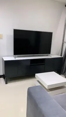a flat screen tv sitting on a black entertainment center at Luxurious Stay in Bello