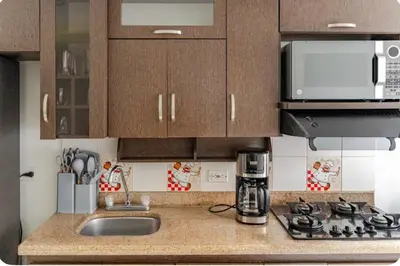 a kitchen counter with a sink and a microwave at Luxurious Stay in Bello