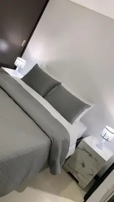 a bedroom with a large bed and two lamps at Luxurious Stay in Bello