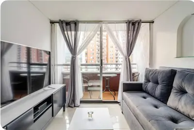 a living room with a couch and a large window at Luxurious Stay in Bello