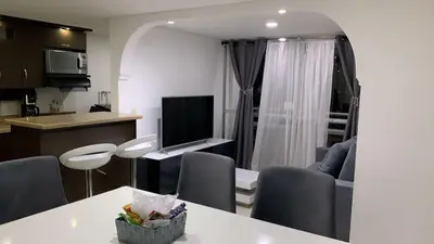 a kitchen and living room with a table and chairs at Luxurious Stay in Bello