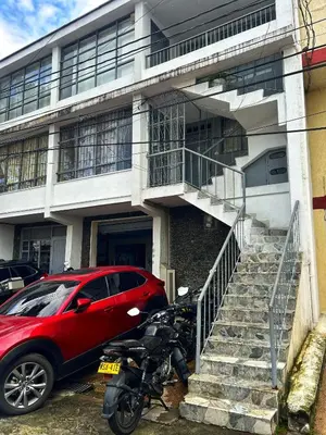 a red motorcycle parked in front of a building at Amplio, Cómodo y tranquilo Apto cerca a Milan y Cable Plaza in Manizales