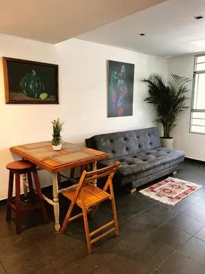 a living room with a couch and a table at Amplio, Cómodo y tranquilo Apto cerca a Milan y Cable Plaza in Manizales