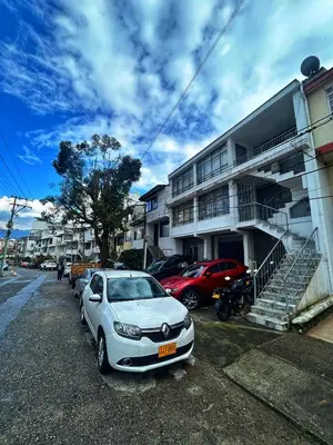 a white car parked in front of a building at Amplio, Cómodo y tranquilo Apto cerca a Milan y Cable Plaza in Manizales