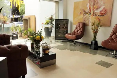 a living room with two chairs and a table at Hotel Lleras 10 in Medellín