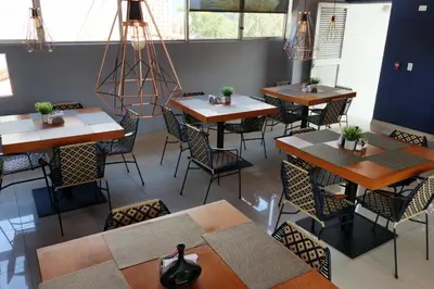 an overhead view of a restaurant with tables and chairs at Hotel Lleras 10 in Medellín