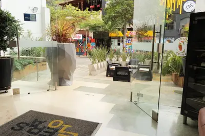 a lobby of a building with tables and chairs at Hotel Lleras 10 in Medellín