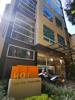 a hotel with a motorcycle parked in front of a building at Hotel Lleras Express in Medellín