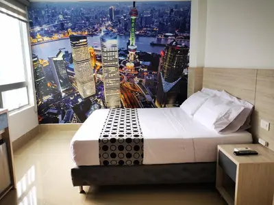 a bedroom with a large poster of a city at Hotel Lleras Express in Medellín