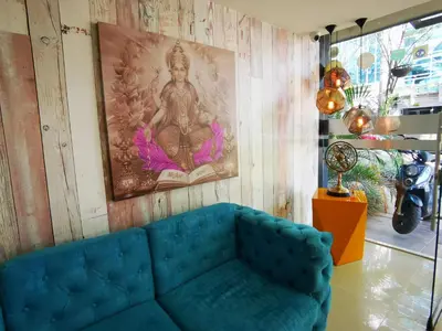 a blue couch in a room with a painting on the wall at Hotel Lleras Express in Medellín