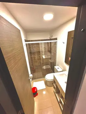 a small bathroom with a toilet and a sink at Hotel Lleras Express in Medellín