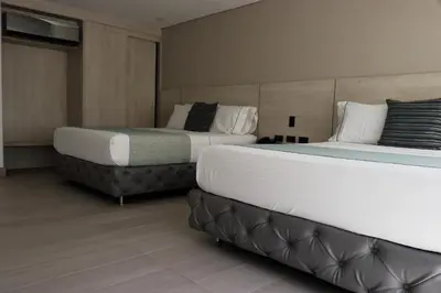 two beds in a hotel room with two bedsskirts at Hotel Loup in Medellín