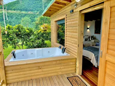 a jacuzzi tub on a deck with a bedroom at Hotel Monteverde Campestre in Concordia