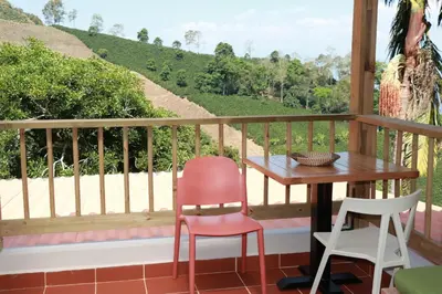 a table and two chairs on a balcony with a view at Hotel Monteverde Campestre in Concordia