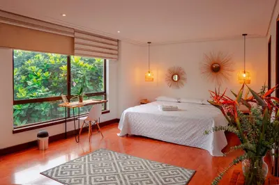 a bedroom with a bed and a desk in it at Habitación de Comfort total en el Poblado - A2 in Medellín