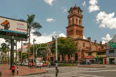 a building with a clock tower on a city street at Habitación de Comfort total en el Poblado - A2 in Medellín