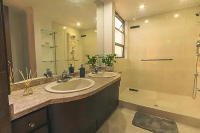 a bathroom with two sinks and a shower at Habitación de Comfort total en el Poblado - A2 in Medellín