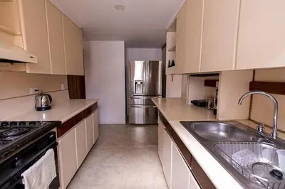 a kitchen with a sink and a stainless steel refrigerator at Habitación de Comfort total en el Poblado - A2 in Medellín