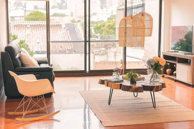 a living room with a table and a chair at Comoda habitacion baño compartido en el Poblado-A4 in Medellín