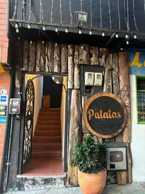 a restaurant with a sign on the front of a building at Casa Raizal in Envigado