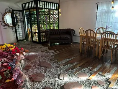 a living room with a couch and a table and chairs at Casa Raizal in Envigado