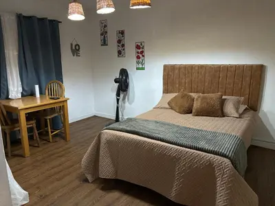 a bedroom with a bed and a desk and a telephone at Casa Raizal in Envigado