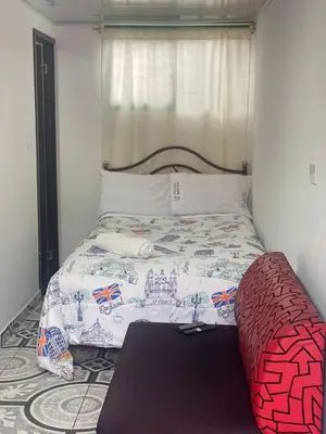 a small bedroom with a bed with a castle blanket at La posada de Martha in Marulanda