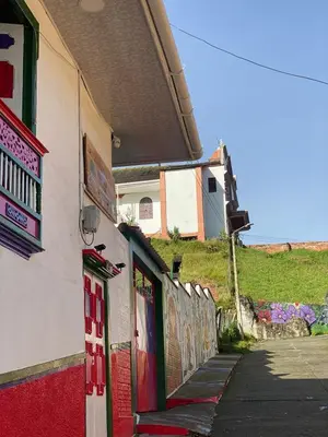 a building with red doors on the side of a street at La posada de Martha in Marulanda