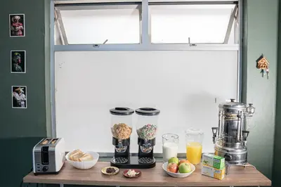 a table with some food and drinks on it at Laureles Garden Hostel in Medellín