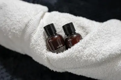 two bottles of soap sitting in a white towel at Laureles Garden Hostel in Medellín