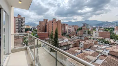 a balcony with a view of a city at Mirador del Laureles, AC, Piscina, Parqueadero 701 in Medellín
