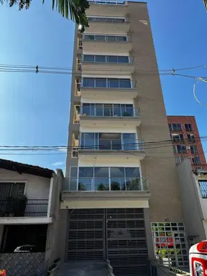 a tall apartment building with a large window at Balcón en Laureles, AC, Piscina, Estacionamiento 601 in Medellín