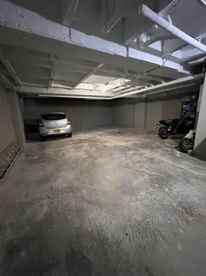 a parking garage with a car parked in it at Balcón en Laureles, AC, Piscina, Estacionamiento 601 in Medellín