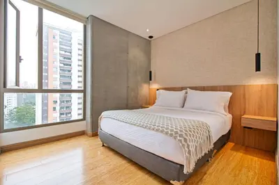 a bedroom with a large bed and large windows at The place to stay in Medellin 802 in Medellín