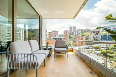 a balcony with two chairs and a view of the city at The place to stay in Medellin 802 in Medellín