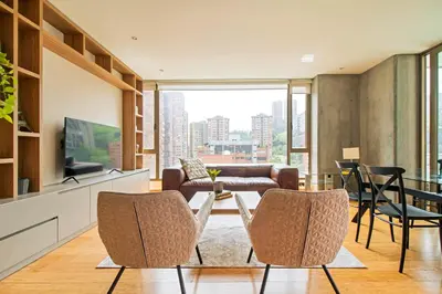 a living room with a couch and a table and chairs at The place to stay in Medellin 802 in Medellín